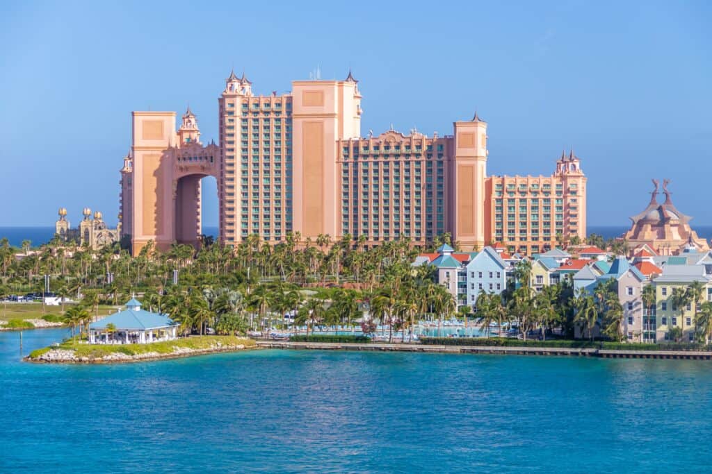 a large building with a large arch over the water with Atlantis Paradise Island in the background representing the bahamas an asset protection jurisdiction